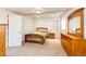 Cozy bedroom with a twin bed, wooden dresser, and a sunny window that provides natural light at 935 Green Gables Cir, Bennett, CO 80102
