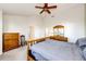 Cozy bedroom features a wooden framed bed, multiple dressers, and access to multiple doors at 935 Green Gables Cir, Bennett, CO 80102