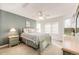 Comfortable bedroom with soothing gray-green wall paint and large windows at 935 Green Gables Cir, Bennett, CO 80102