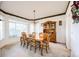 Dining room featuring a traditional hutch and a six place table, alongside a bay window at 935 Green Gables Cir, Bennett, CO 80102