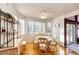Bright dining area featuring a decorative chandelier, large windows, and stylish furnishings at 935 Green Gables Cir, Bennett, CO 80102