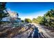 Long winding driveway leading to a well-maintained home and lush landscaping at 935 Green Gables Cir, Bennett, CO 80102
