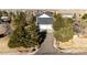 Long driveway leading to a three-car garage at 935 Green Gables Cir, Bennett, CO 80102