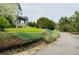 Well-manicured front yard with mature landscaping and a winding driveway at 935 Green Gables Cir, Bennett, CO 80102