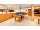 Basement game room with large pool table, custom cabinetry, and comfortable lighting perfect for entertainment at 935 Green Gables Cir, Bennett, CO 80102