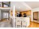 Kitchen featuring wooden cabinetry, long countertop with barstool seating and an view of the stairs at 935 Green Gables Cir, Bennett, CO 80102