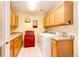 Functional laundry room with washer, dryer, ample cabinetry, and counter space at 935 Green Gables Cir, Bennett, CO 80102