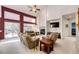 Living room with multiple seating areas, large glass doors, carpet flooring, and a fireplace at 935 Green Gables Cir, Bennett, CO 80102