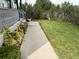 A walkway leads to the front door, complemented by lush landscaping and greenery at 935 Green Gables Cir, Bennett, CO 80102