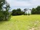 Expansive green lawn with scattered trees offering privacy and scenic views at 935 Green Gables Cir, Bennett, CO 80102