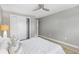 Bright bedroom featuring a ceiling fan, closet, and white bedding, offering a clean and modern aesthetic at 159 Judson St, Longmont, CO 80501