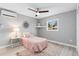Inviting bedroom with a ceiling fan, a window offering natural light, and a calming color scheme at 159 Judson St, Longmont, CO 80501