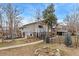 Two story home with fenced yard, driveway, and mature trees on a sunny day at 159 Judson St, Longmont, CO 80501