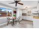 Sun-filled kitchen featuring white cabinets, modern appliances, and adjacent dining area at 159 Judson St, Longmont, CO 80501