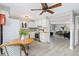 Bright eat-in kitchen with modern appliances, stylish ceiling fan, and views into the living room at 159 Judson St, Longmont, CO 80501