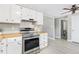 Kitchen featuring stainless steel oven and hood, white cabinets and light grey walls at 159 Judson St, Longmont, CO 80501