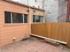 Enclosed backyard with brick patio, featuring a privacy fence and exterior building detail at 1767 N Washington St, Denver, CO 80203