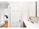 Bright half bath with modern sink and updated fixtures adjacent to a bedroom with wood floors at 1767 N Washington St, Denver, CO 80203