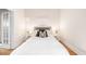 Bright bedroom with white bedding, two bedside tables with lamps and neutral paint at 1767 N Washington St, Denver, CO 80203