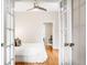 French doors open to a bright bedroom with hardwood floors and access to an office at 1767 N Washington St, Denver, CO 80203