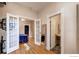 Bright bedroom with French doors, hardwood floors, and a bathroom, creating an inviting space at 1767 N Washington St, Denver, CO 80203
