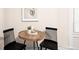 Charming dining area with a round table, black chairs, and stylish decor at 1767 N Washington St, Denver, CO 80203