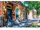 Charming brick building exterior, sidewalk and mature trees creating a pleasant outdoor setting at 1767 N Washington St, Denver, CO 80203