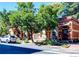 Charming brick building with mature trees, a car parked nearby, adding to the curb appeal at 1767 N Washington St, Denver, CO 80203