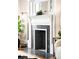 Close-up of a decorative fireplace featuring a mantel and black tile surround at 1767 N Washington St, Denver, CO 80203