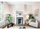 Living room featuring a decorative fireplace, hardwood floors, and ample natural light at 1767 N Washington St, Denver, CO 80203