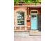 Charming brick home featuring an arched window, blue door, and brick details at 1767 N Washington St, Denver, CO 80203