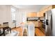 Bright kitchen with stainless steel appliances, an island, and hardwood floors at 1767 N Washington St, Denver, CO 80203
