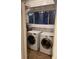Functional laundry room with a window, shelving, and modern washer and dryer units at 1767 N Washington St, Denver, CO 80203