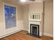 Cozy living room with a fireplace, large window, and hardwood floors, perfect for relaxation at 1767 N Washington St, Denver, CO 80203
