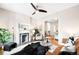 Open living room with fireplace, hardwood floors, and a glimpse into the adjacent kitchen at 1767 N Washington St, Denver, CO 80203