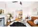 Cozy living room showcasing a fireplace, hardwood floors, and an open doorway to the kitchen at 1767 N Washington St, Denver, CO 80203