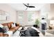 Bright living room featuring a brown leather sofa, decorative fireplace, and modern ceiling fan at 1767 N Washington St, Denver, CO 80203