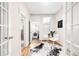 Bright office with french doors leading to a laundry room; featuring a modern desk and hardwood floors at 1767 N Washington St, Denver, CO 80203