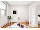 Bright office with french doors, a modern desk, a cowhide rug and hardwood floors at 1767 N Washington St, Denver, CO 80203