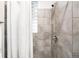Updated shower featuring neutral tile, glass block window, and modern shower head at 1767 N Washington St, Denver, CO 80203