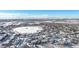 Aerial view of community with lake in winter with snow capped mountains at 12961 Lafayette St # B, Thornton, CO 80241