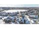 Aerial view of snow covered homes near a frozen lake at 12961 Lafayette St # B, Thornton, CO 80241