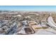 Aerial view of neighborhood with large school complex in winter scenery at 12961 Lafayette St # B, Thornton, CO 80241