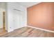 Bright bedroom boasts stylish laminate floors and closet with sliding doors at 12961 Lafayette St # B, Thornton, CO 80241