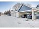 A row of garages and carports sit in a snowy landscape at 12961 Lafayette St # B, Thornton, CO 80241