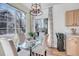 Kitchen dining area with glass table and sliding door access to a patio at 12961 Lafayette St # B, Thornton, CO 80241