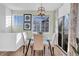 Bright dining area with glass table, four chairs and large windows at 12961 Lafayette St # B, Thornton, CO 80241