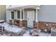 Charming covered front porch with brick supports, address numbers, and a bench at 12961 Lafayette St # B, Thornton, CO 80241