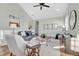 Bright living room featuring vaulted ceiling, hardwood floors, and modern decor at 12961 Lafayette St # B, Thornton, CO 80241