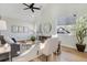 Living room with hardwood floors, large windows, and a ceiling fan at 12961 Lafayette St # B, Thornton, CO 80241